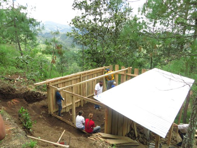 Manuela's house in the process of being built on the side of a mountain.