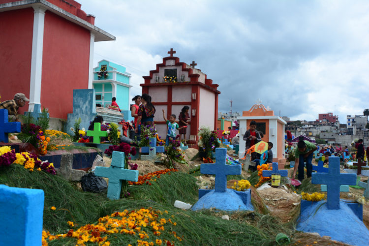Families decorate the tombs of their ancestors on All Saints Day in Chichicastenango, Guatemala.