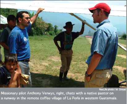 Missionary pilot Anthony Verwys, right, chats with a native pastor on a runway in the remote coffee village of La Perla in western Guatemala.