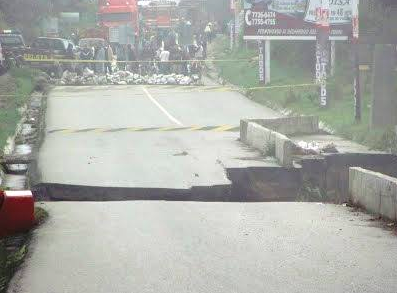 This image shows where the road washed away and left a gaping canyon where the road use to be. 