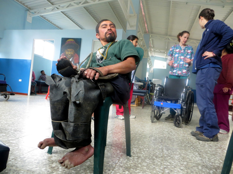 Here's Tomas wearing his rugged rubber pants. His wheelchair is being prepared behind him.