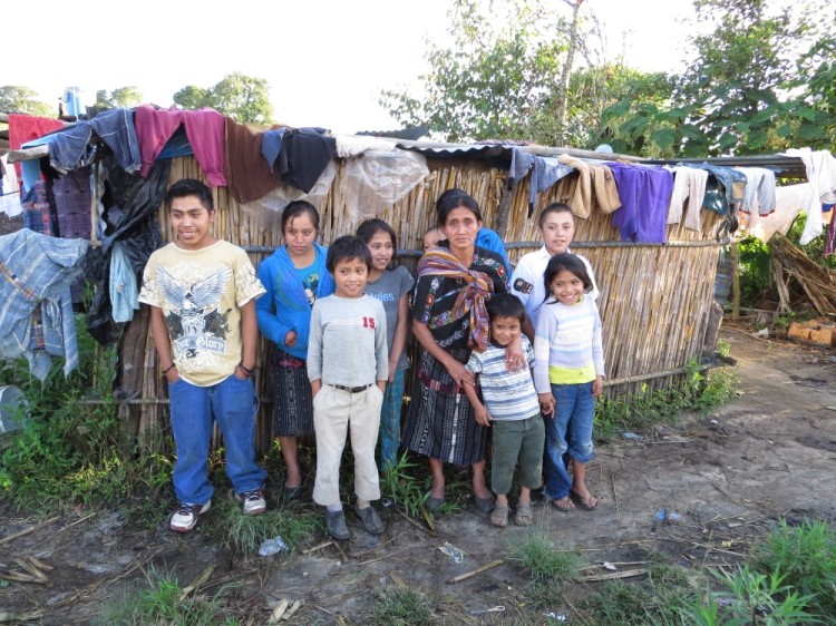 Mario and his family in front of their home.