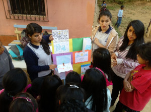 Grecia, Chochi, and Patti explaining a craft project to the kids.