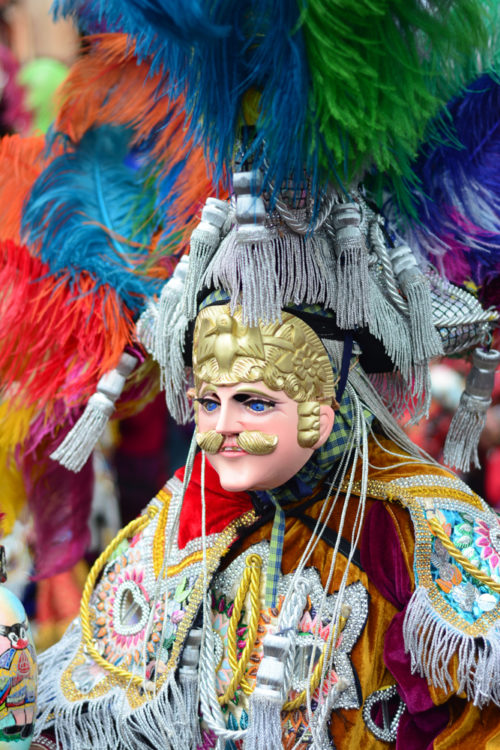 A dancer wearing a mask and feathers during the celebrations in Chichicastenango for All Saints Day.