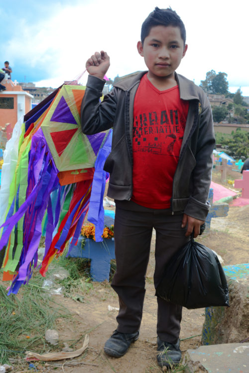 A kite salesboy selling kites for about 70 cents (US).